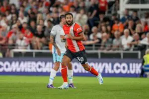 Andros Townsend wearing the Luton Town Football Club shirt with Star Platforms on the sleeve