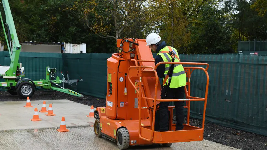 hard hat use on a boom lift A trainee completes their IPAF certification whilst wearing a hard hat on a boom lift